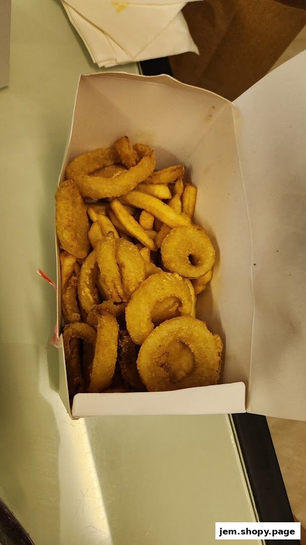A box filled with crispy onion rings and french fries from MOS Burger.