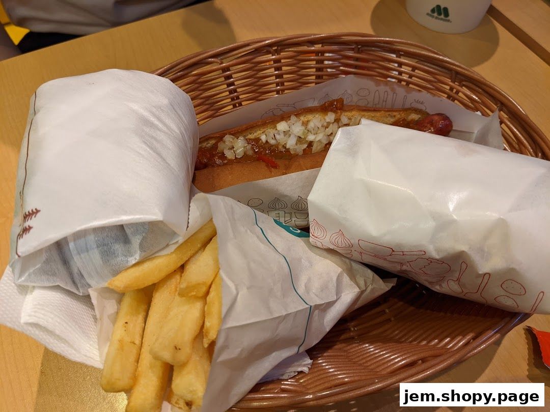 A basket filled with a hot dog, french fries, and a wrapped item from MOS Burger.