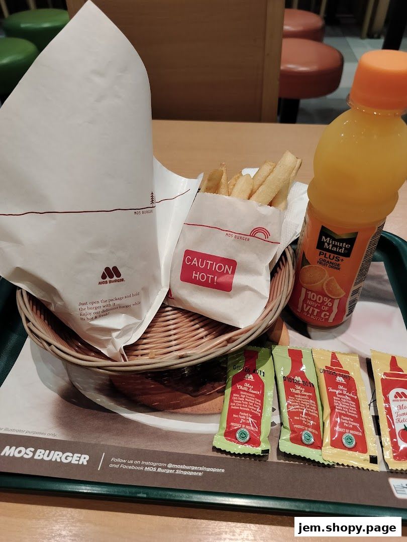 A MOS Burger meal featuring a burger, fries, and orange juice on a tray.