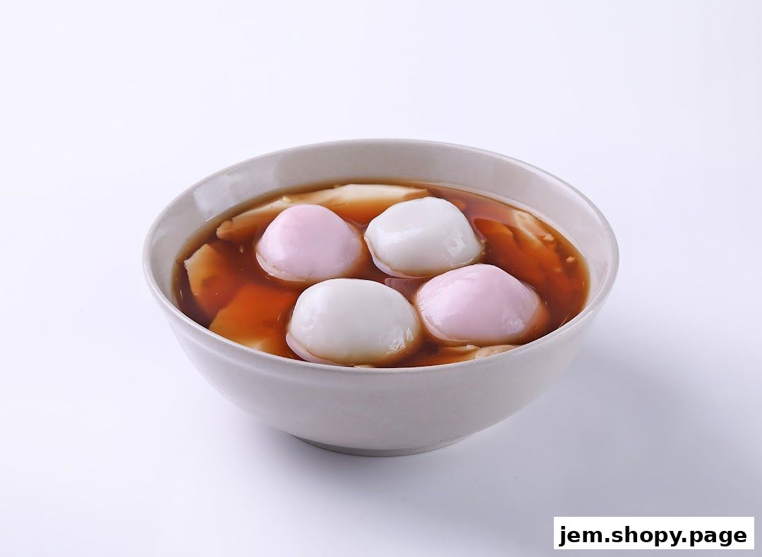 A bowl of sweet tofu pudding with colorful mochi balls in a brown syrup.