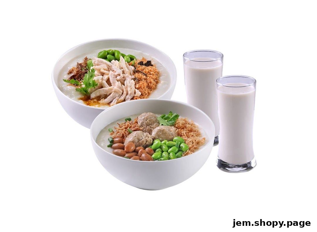Two bowls of congee with toppings and two glasses of milk.