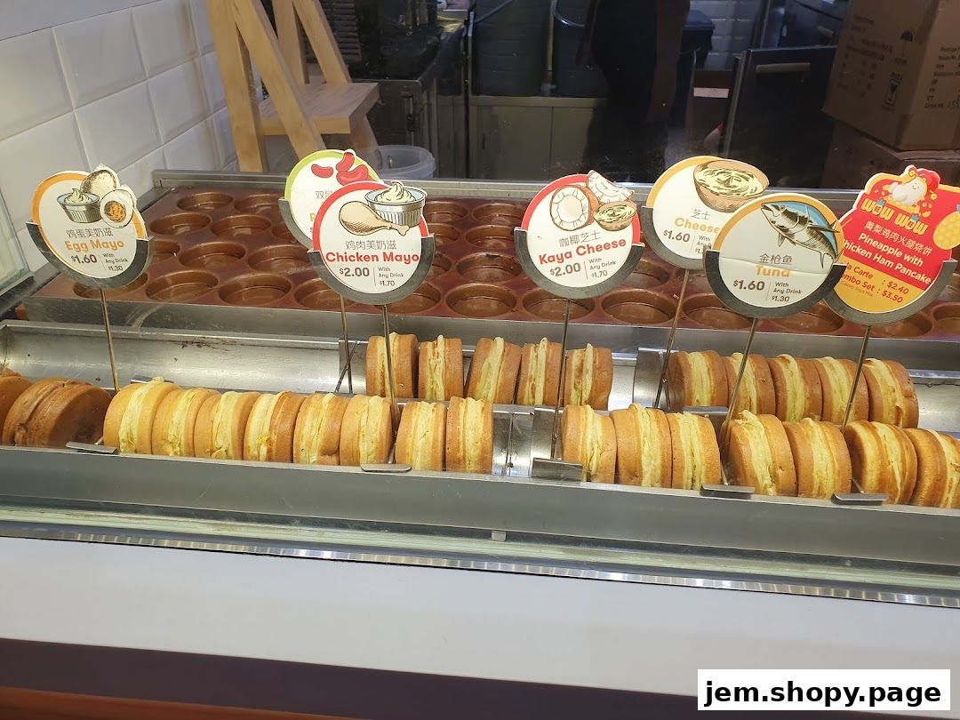 A display of freshly made pancakes with various fillings and price tags.