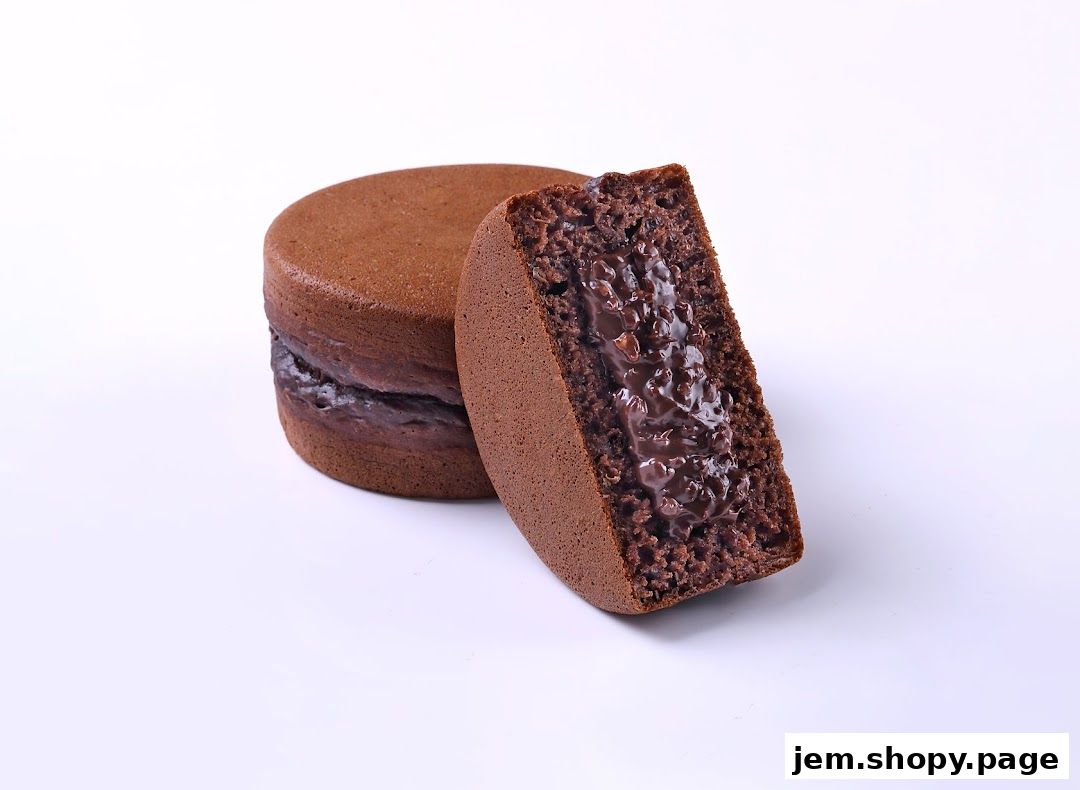 A close-up shot of a chocolate-filled pancake or cake, with one piece cut to reveal the rich filling.
