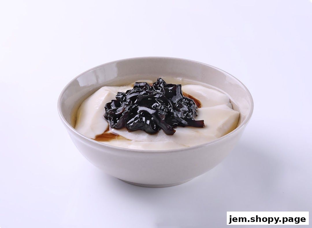 A bowl of silky smooth tofu pudding topped with dark syrup and chewy toppings.