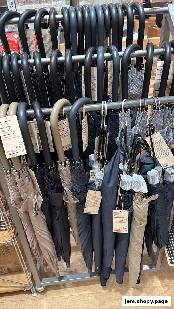 A display of various MUJI umbrellas in different colors and styles.