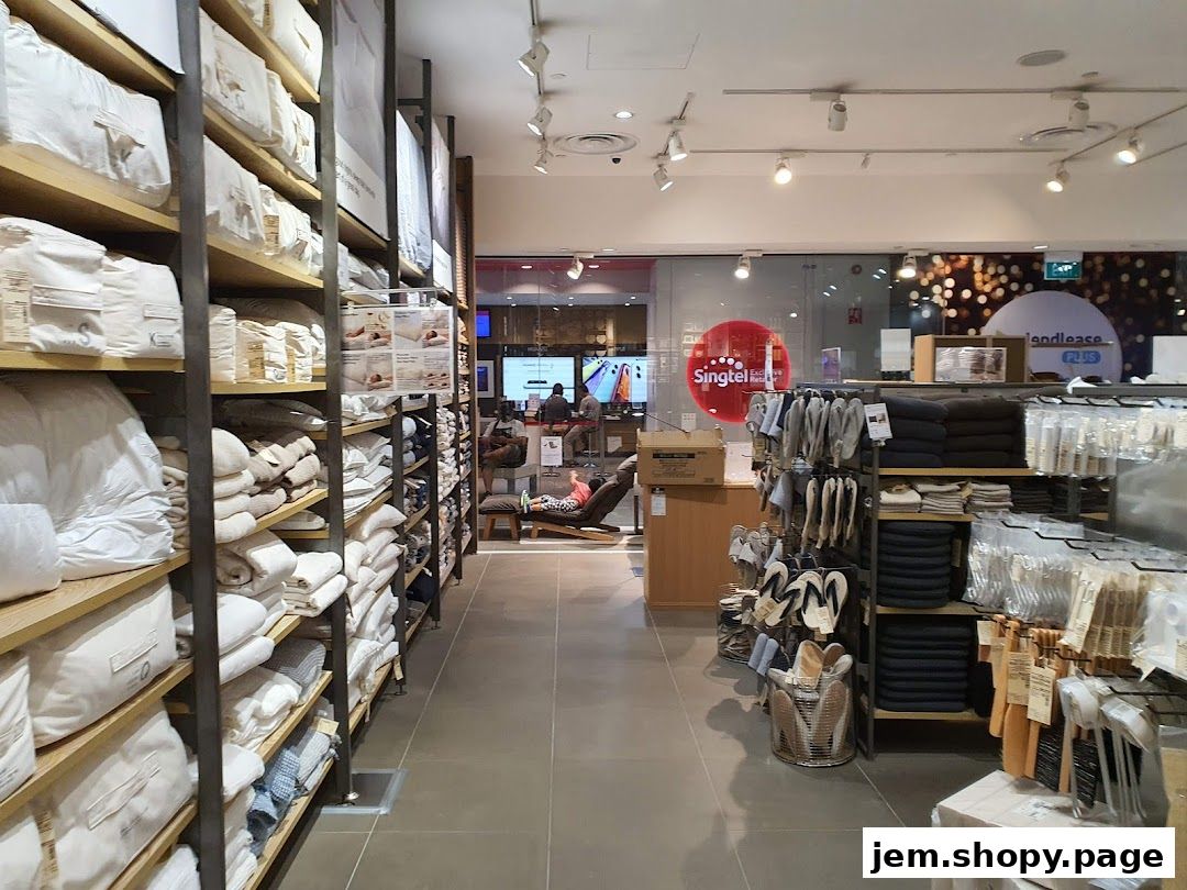 Interior view of a MUJI store showcasing bedding, apparel, and home goods.