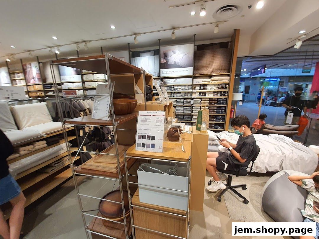 Interior view of a MUJI store showcasing furniture, bedding, and home goods.