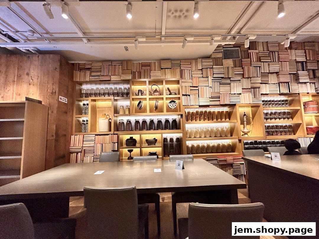 Interior of MUJI JEM shop with shelves filled with books and jars of goods.
