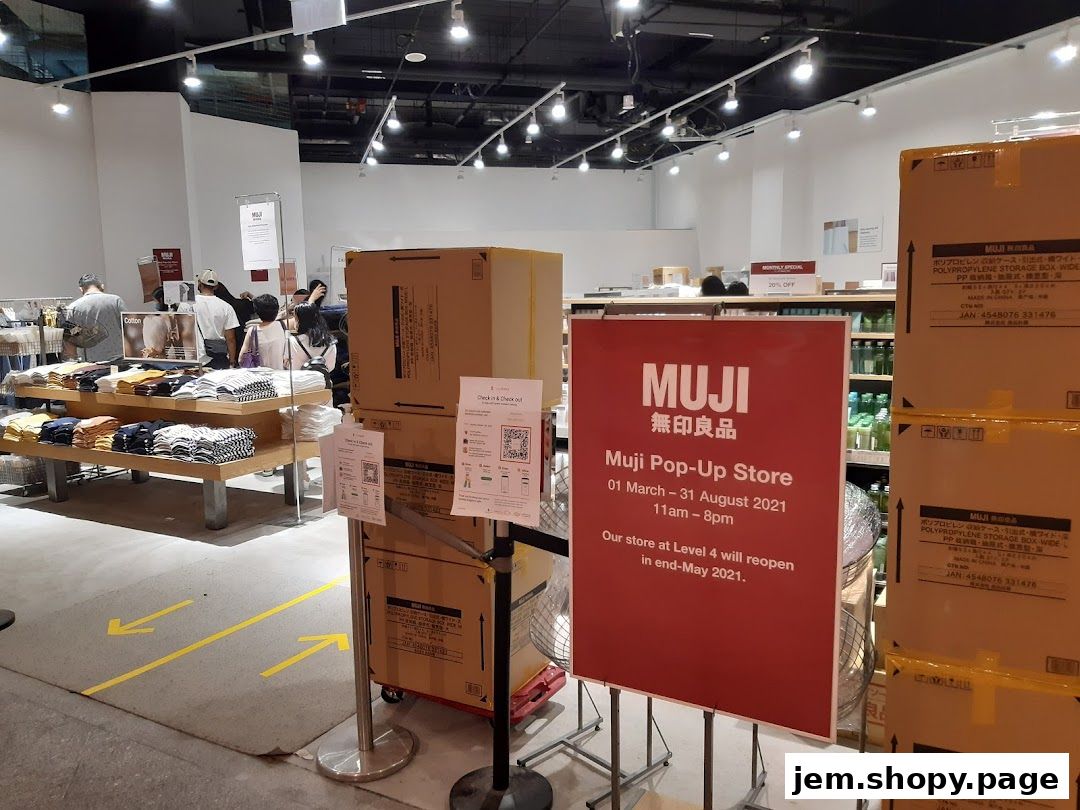 Interior view of a MUJI pop-up store with clothing displays and product boxes.