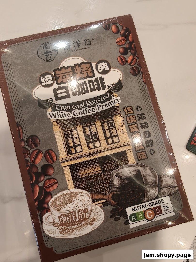 A box of Nan Yang Dao Charcoal Roasted White Coffee Premix with coffee beans and a cup of coffee.