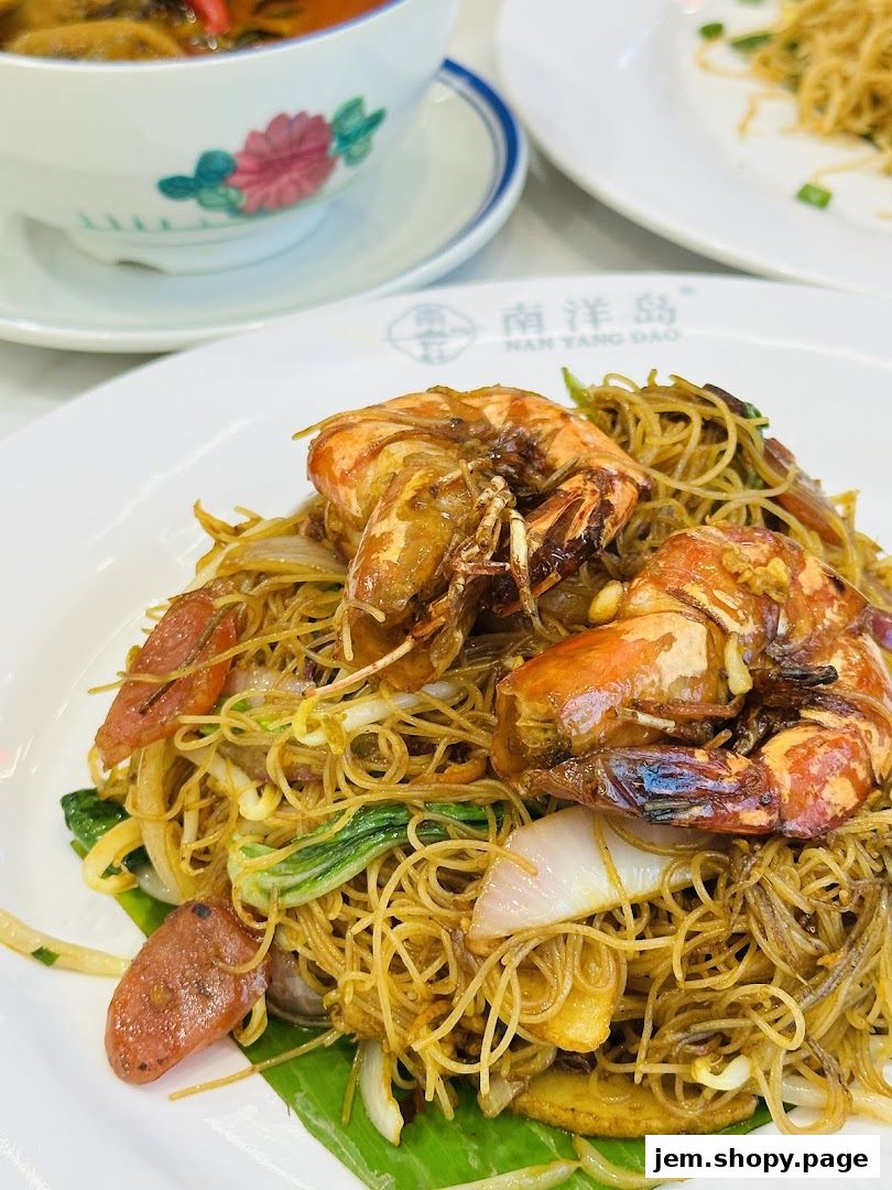 A plate of stir-fried noodles with large prawns and sausage, served at Nan Yang Dao.