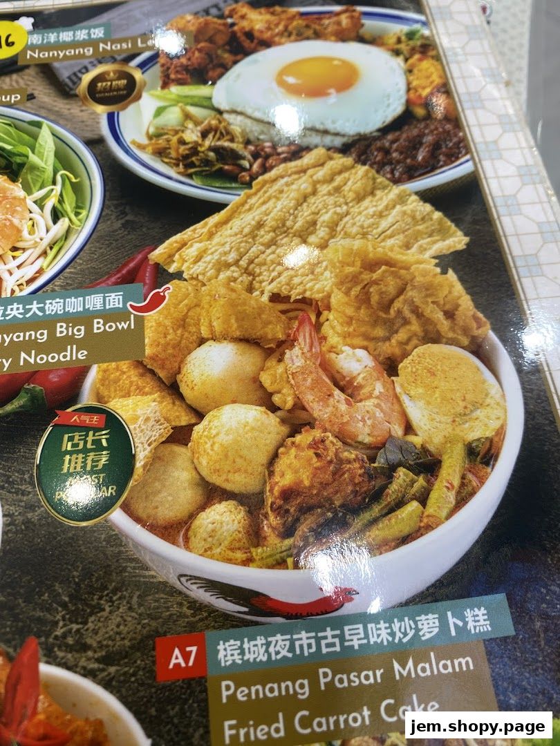 A close-up of a menu featuring Nanyang Nasi Lemak and Penang Fried Carrot Cake.