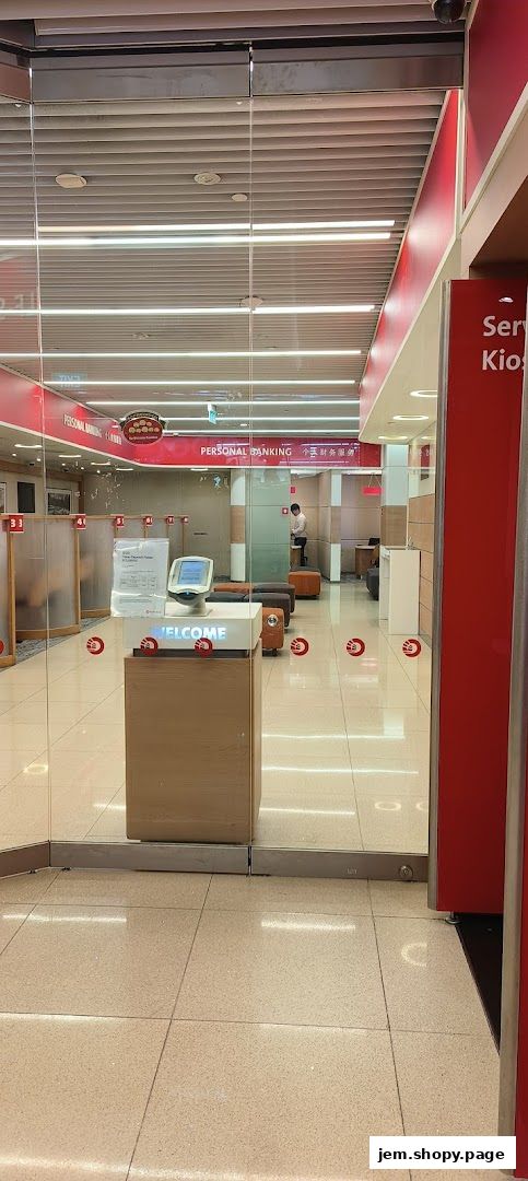Entrance to OCBC Bank JEM, featuring glass doors, a welcome kiosk, and personal banking signage.