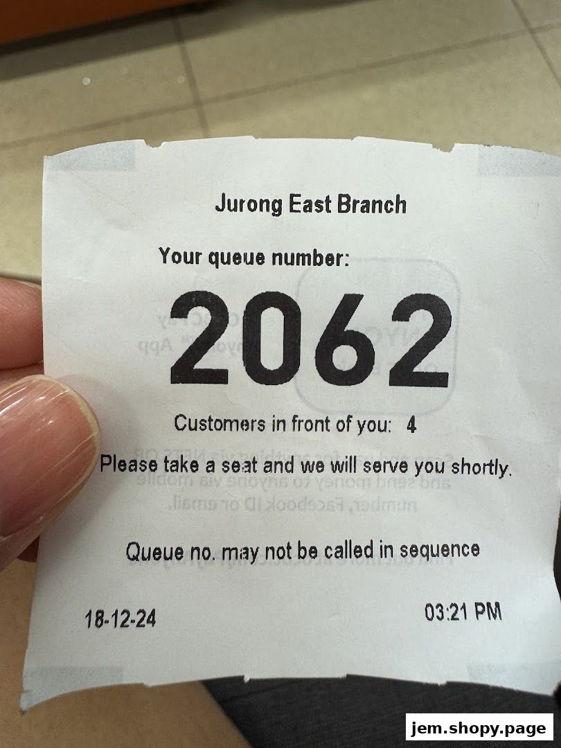 A queue ticket from OCBC Bank Jurong East Branch with number 2062.