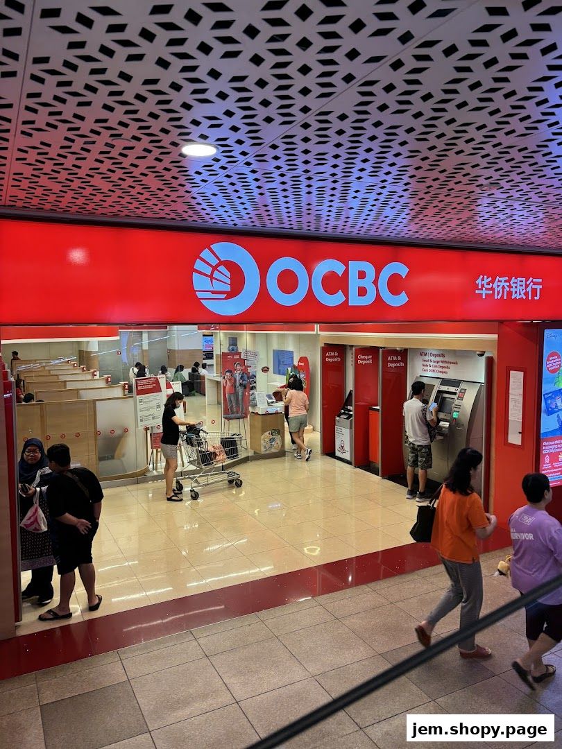 The entrance of an OCBC Bank branch with ATMs and customers.
