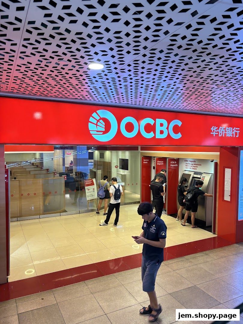 The entrance of an OCBC Bank branch with customers using ATMs and staff inside.