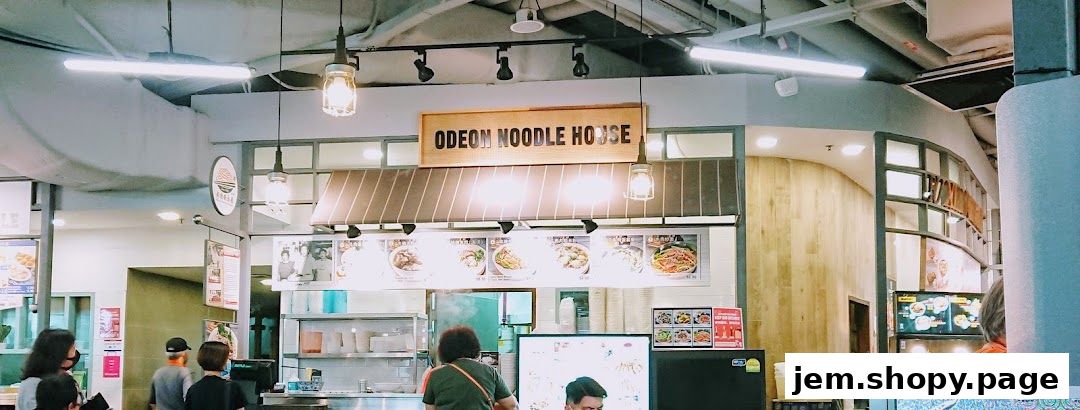 Odeon Beef Noodles shop front with menu displays and customers.