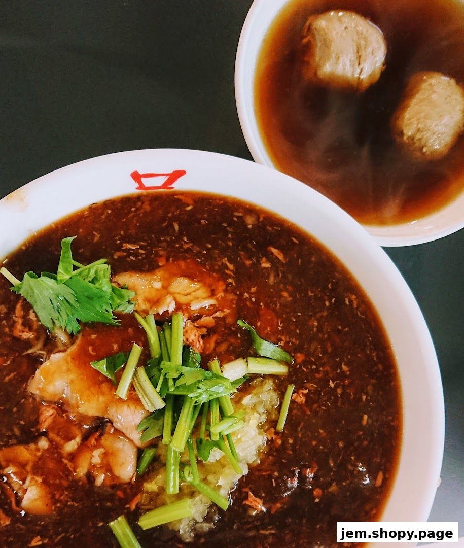 Two bowls of beef noodles, one with meat and greens, the other with meatballs.