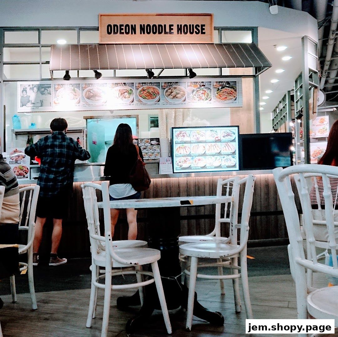 Odeon Noodle House storefront with customers ordering and menu displays.