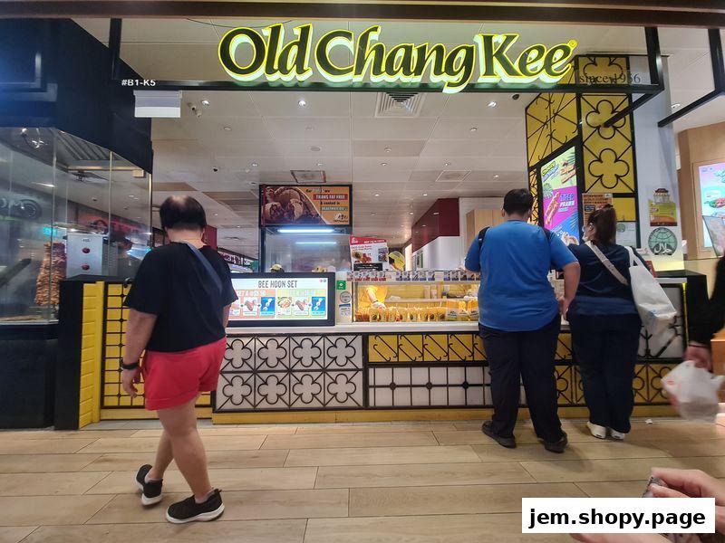 Old Chang Kee shop front with customers ordering food.