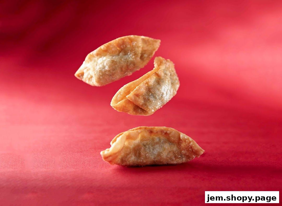 Three golden fried dumplings are artfully arranged against a vibrant red background.