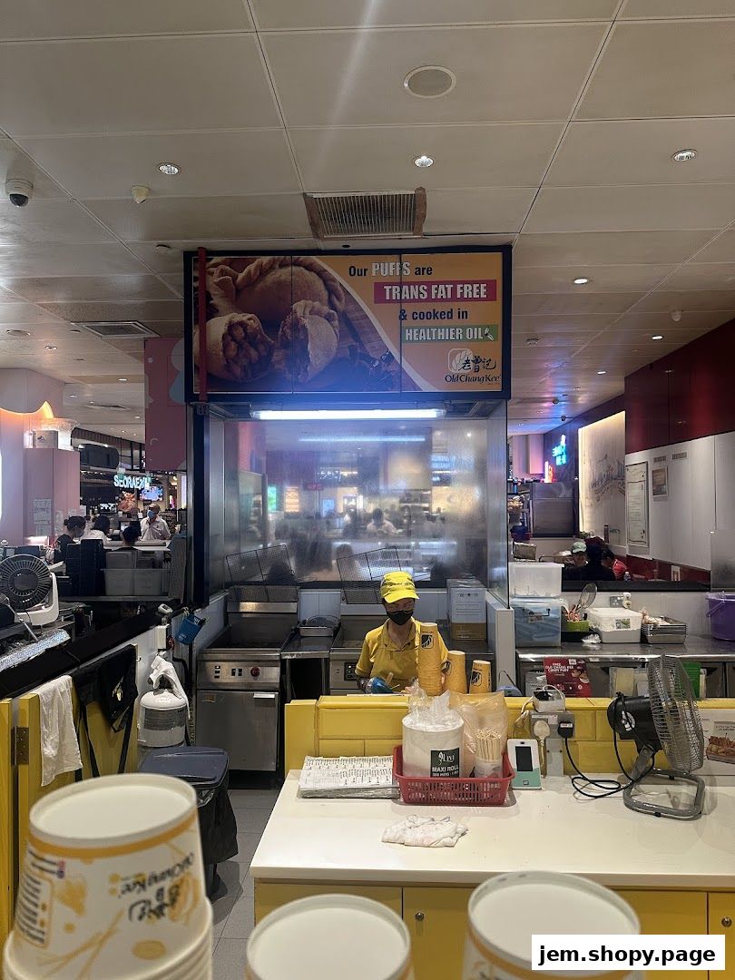An Old Chang Kee counter with a sign advertising trans fat-free puffs cooked in healthier oil.