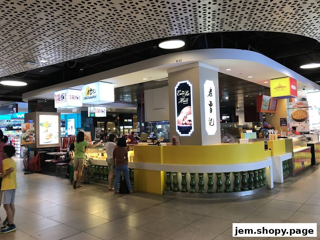 The Old Chang Kee shop front with customers ordering food.