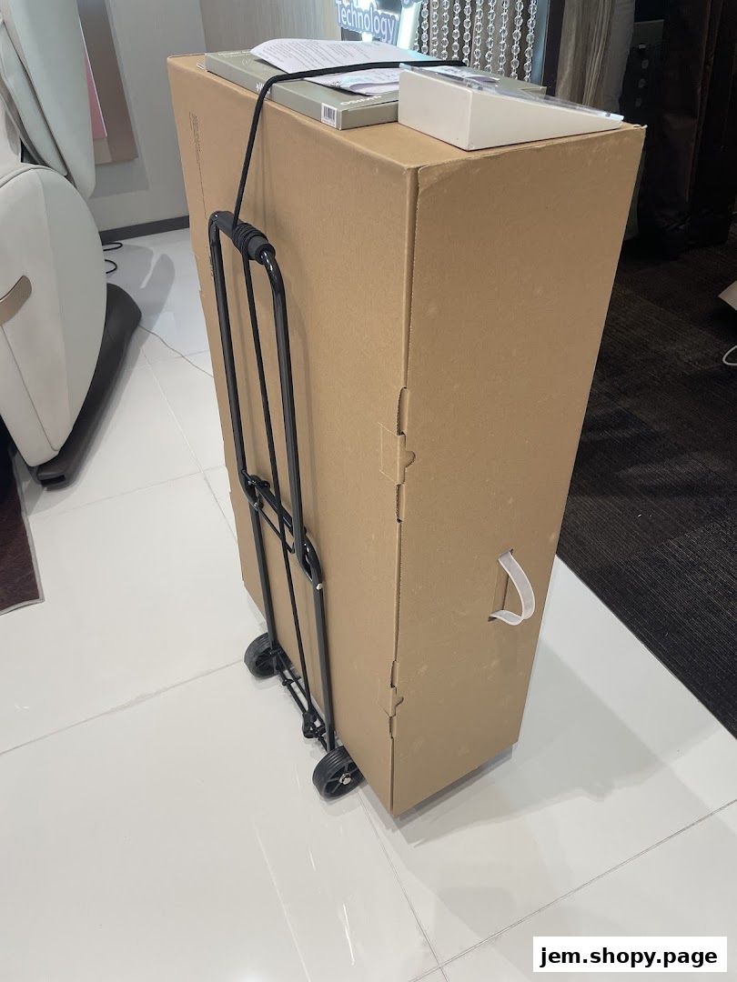 A large cardboard box with a foldable trolley attached, ready for transport.