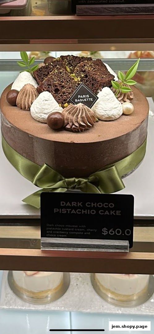 A decadent chocolate pistachio cake with intricate frosting and chocolate decorations.