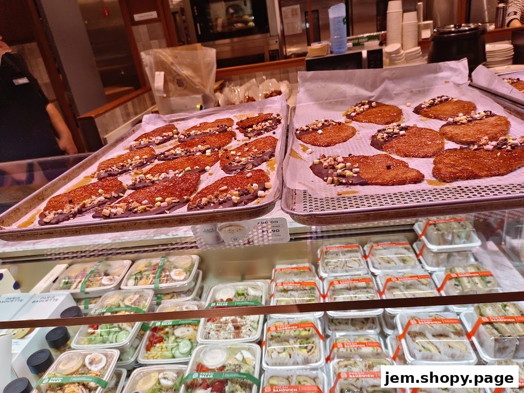 A display of freshly baked pastries and pre-packaged salads and sandwiches at Paris Baguette.