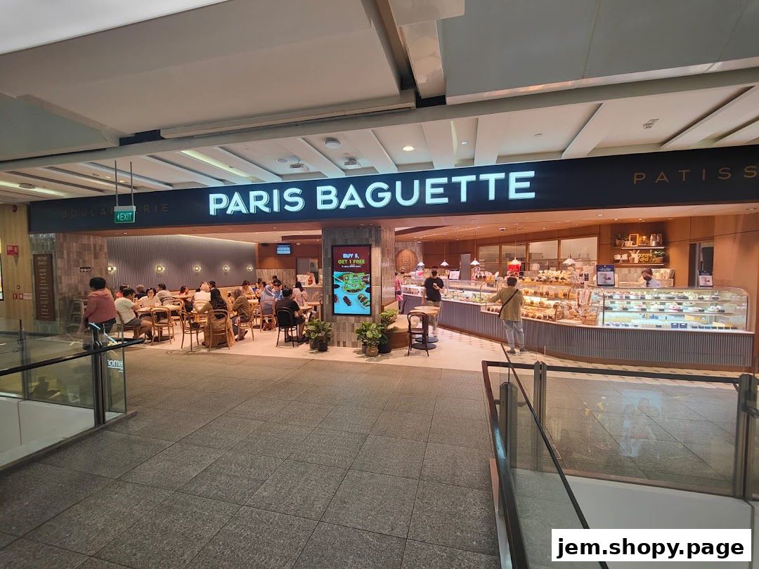 Paris Baguette shop front with display cases, seating area, and customers.