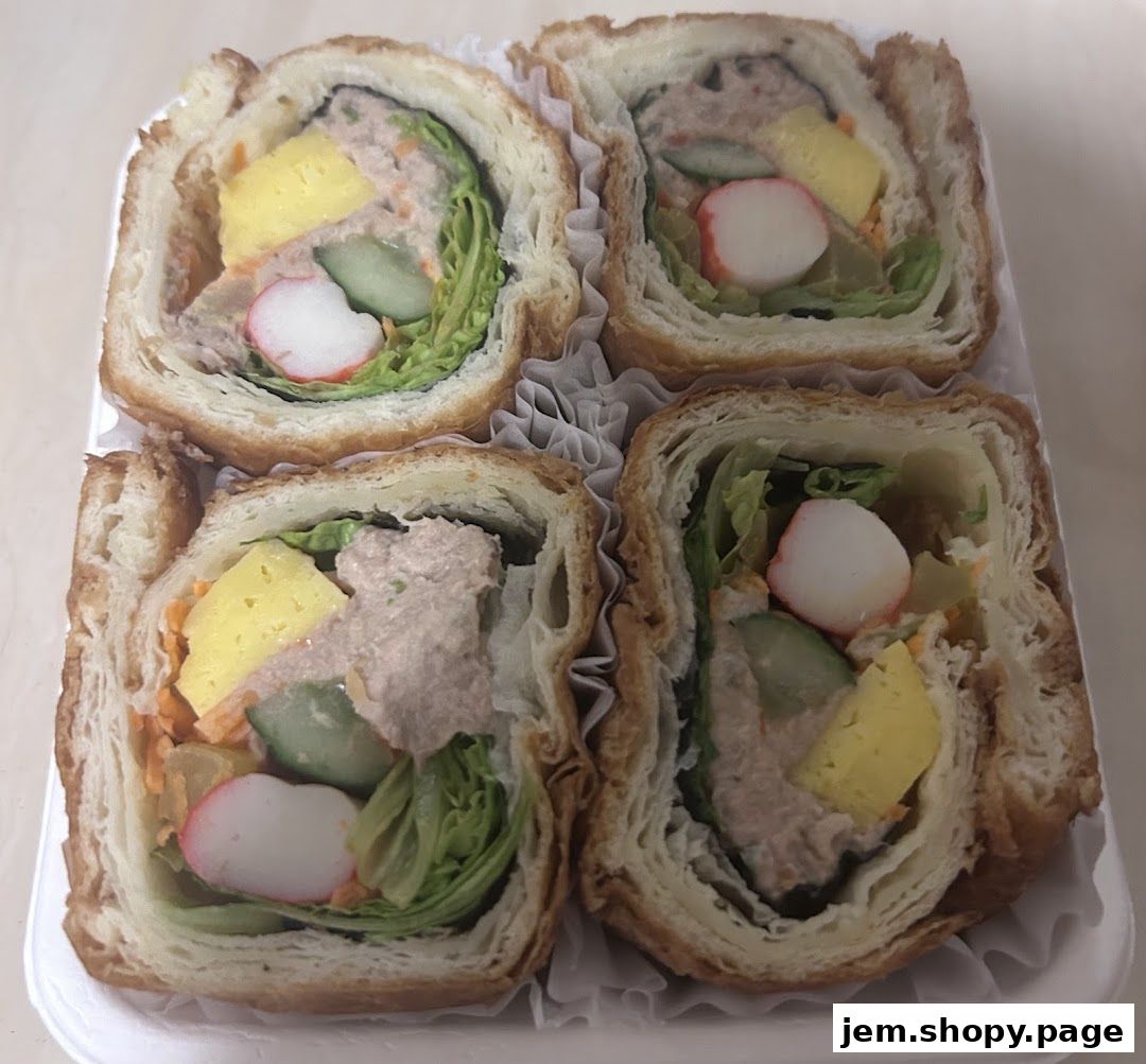Four savory pastry rolls filled with tuna salad, vegetables, and egg.