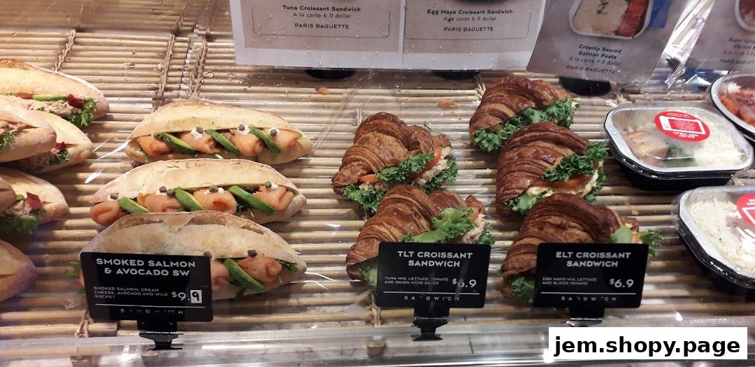 A display of fresh sandwiches and croissants at Paris Baguette.