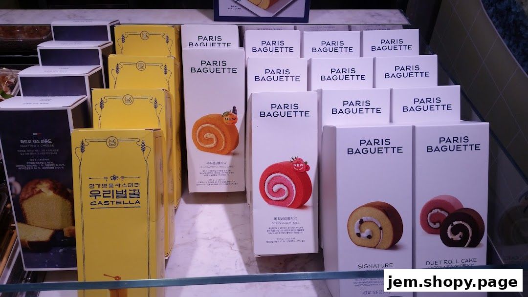 Paris Baguette display of various cakes and pastries in their branded packaging.