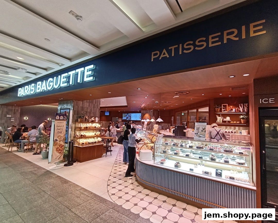 Exterior view of Paris Baguette Jem, a patisserie with display cases filled with cakes and pastries.