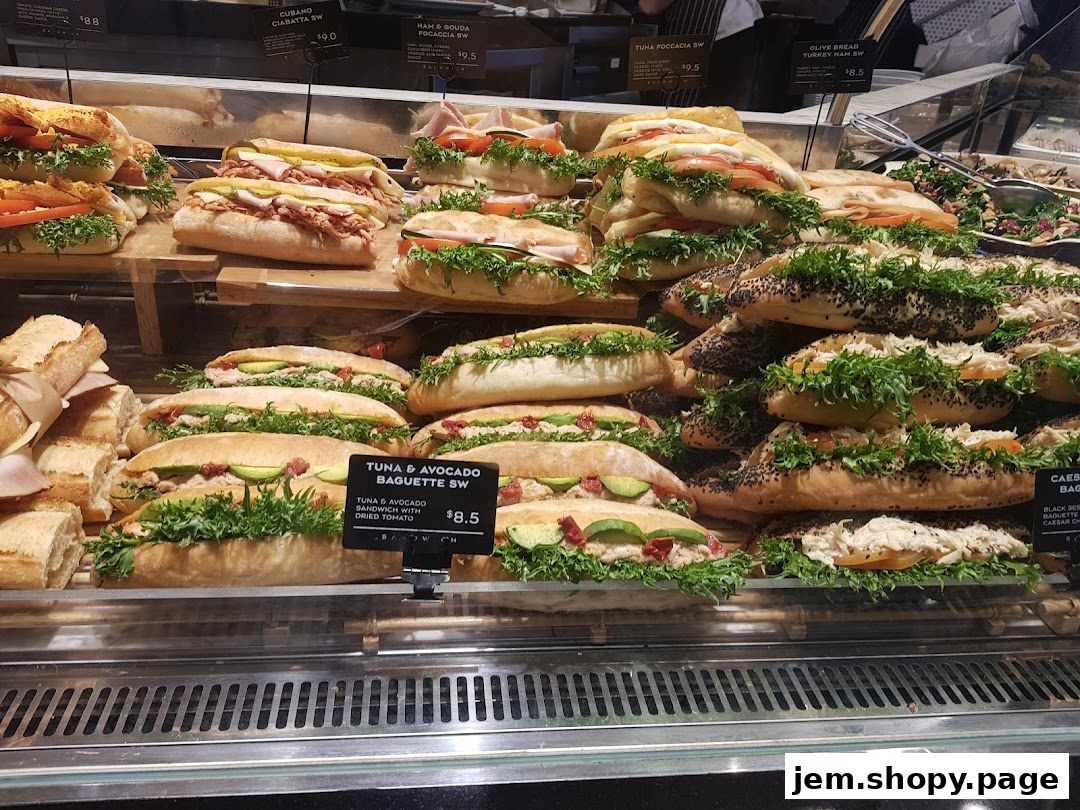 A display of fresh sandwiches and baguettes with various fillings and toppings.