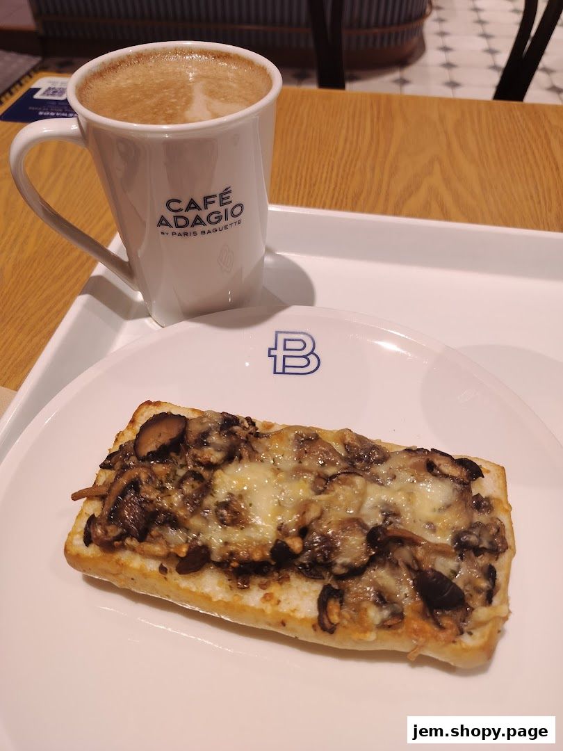 A mushroom and cheese tartine served with a latte at Cafe Adagio by Paris Baguette.