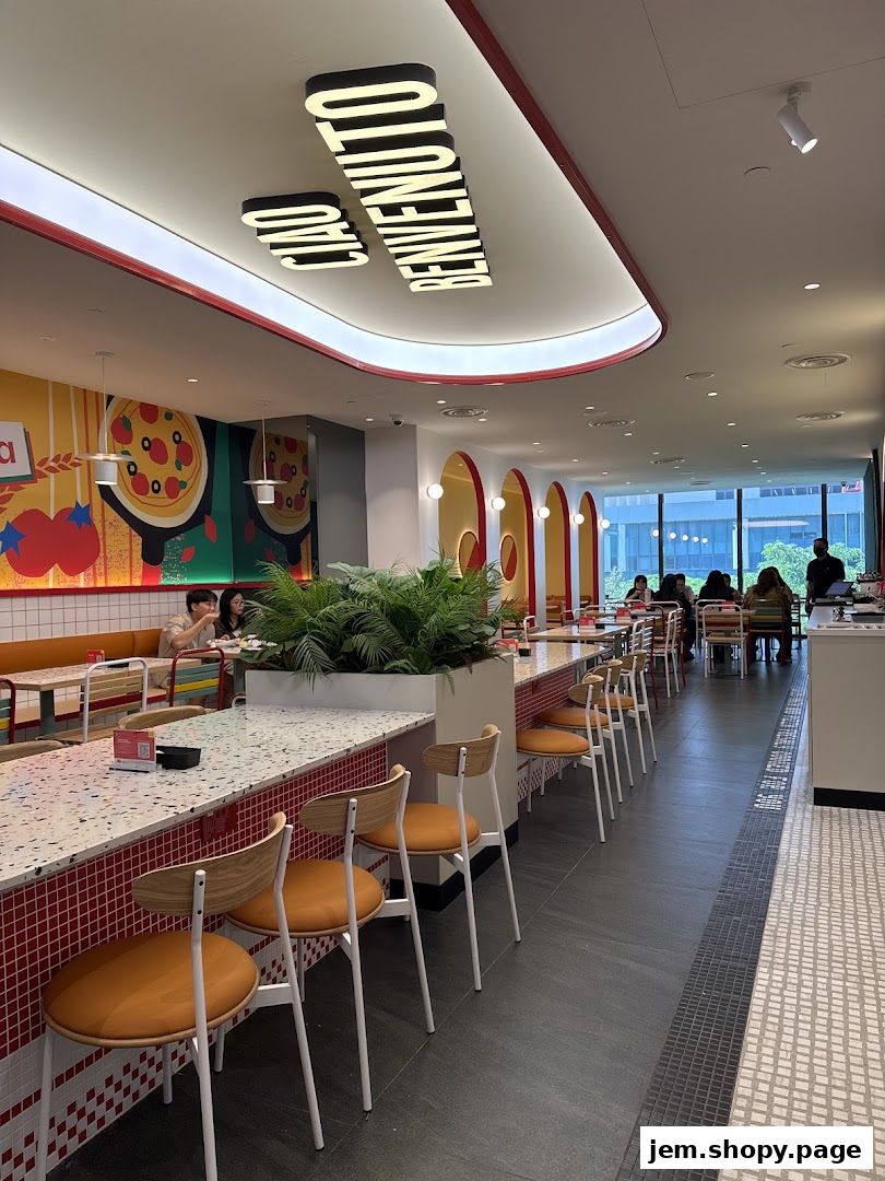 Interior view of PastaMania restaurant with seating, decor, and diners.