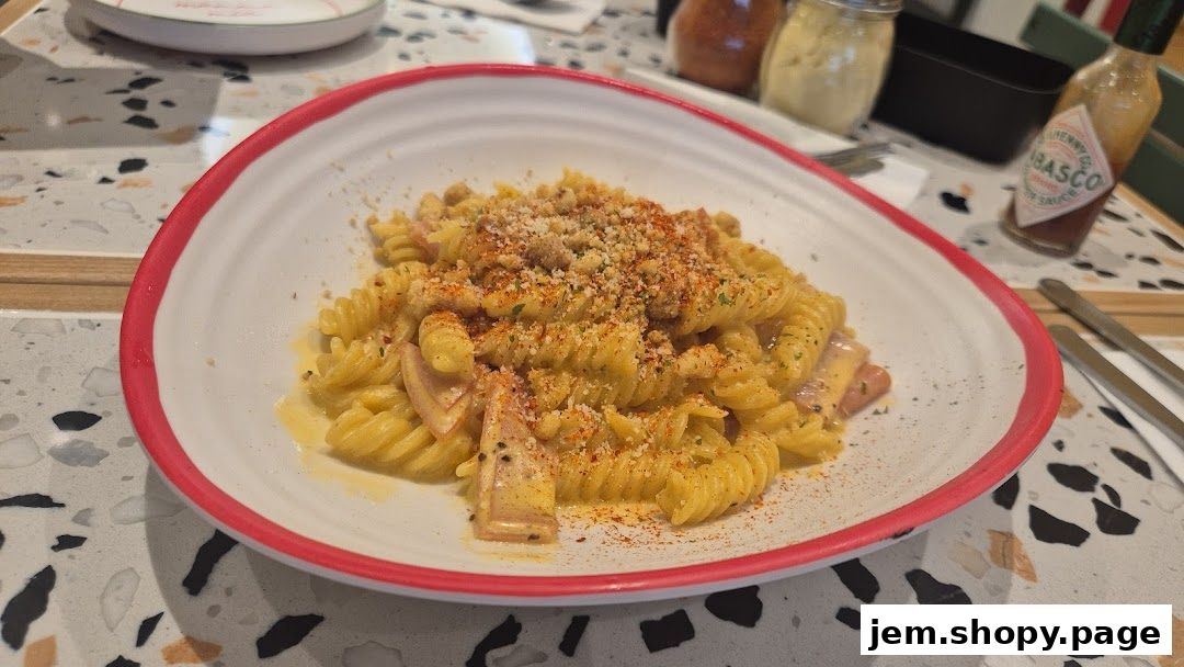 A close-up shot of a delicious pasta dish with fusilli noodles and a creamy sauce.