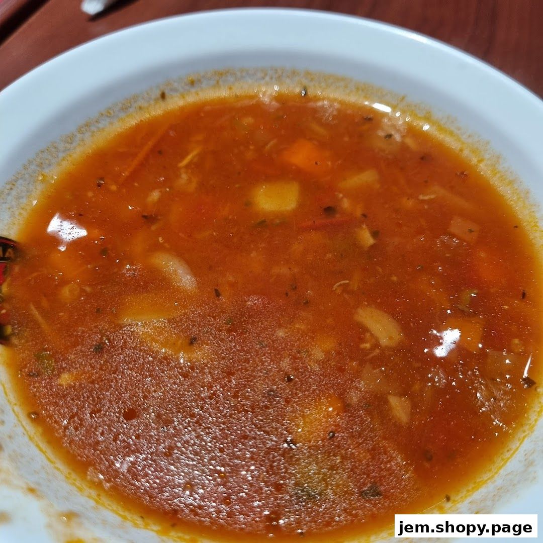 A close-up shot of a hearty bowl of Italian vegetable soup.