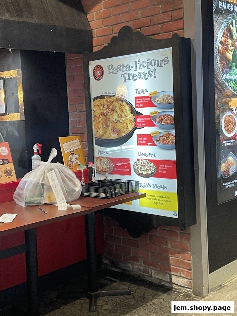 A menu board for PastaMania featuring pasta, pizza, dessert, and kid's meals.