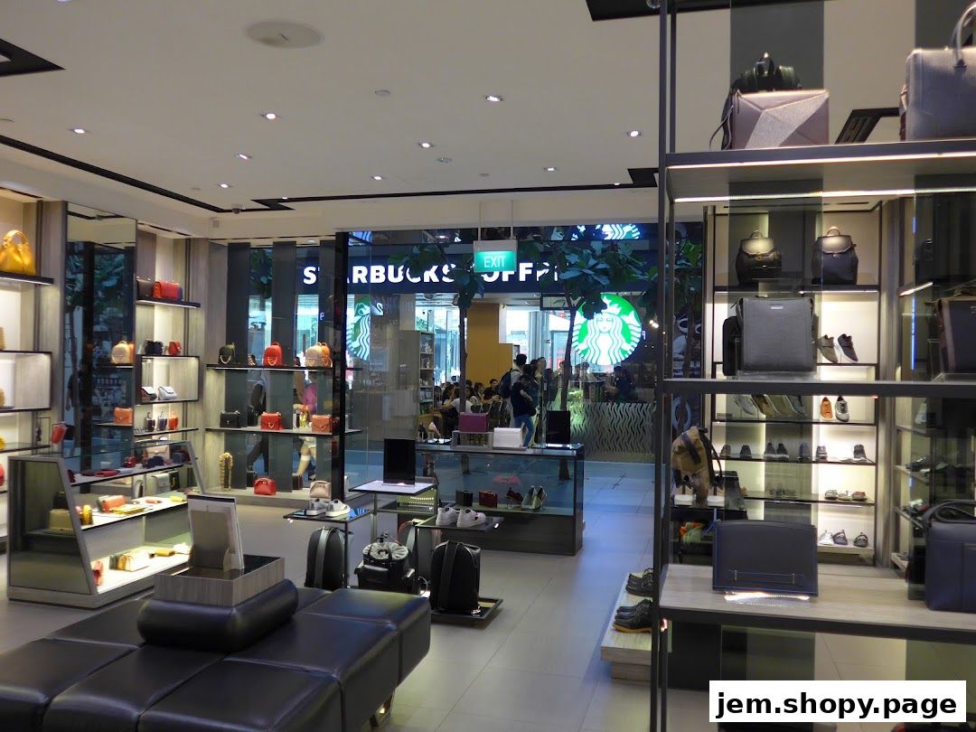 Interior view of a PEDRO Jem store showcasing handbags and shoes on display shelves.