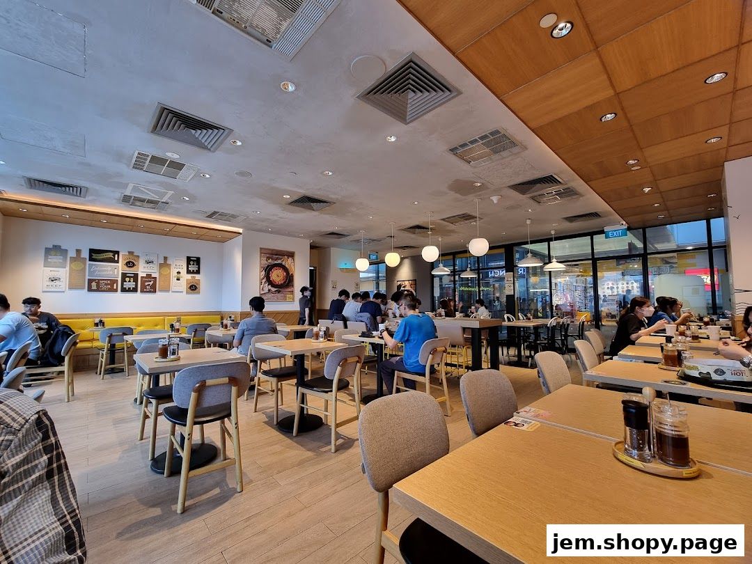 Interior of a busy Pepper Lunch restaurant with diners seated at tables.