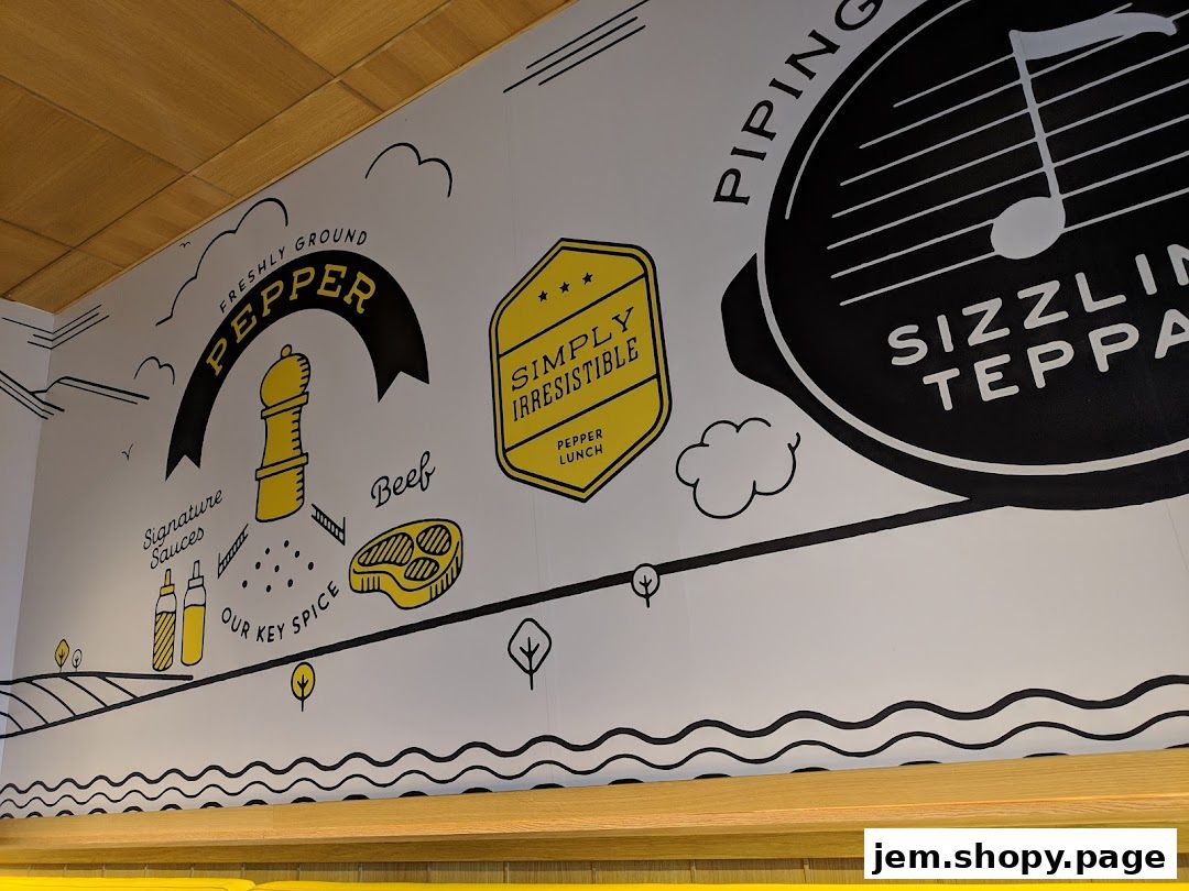 Wall art featuring Pepper Lunch's signature ingredients and 'sizzling teppan' concept.