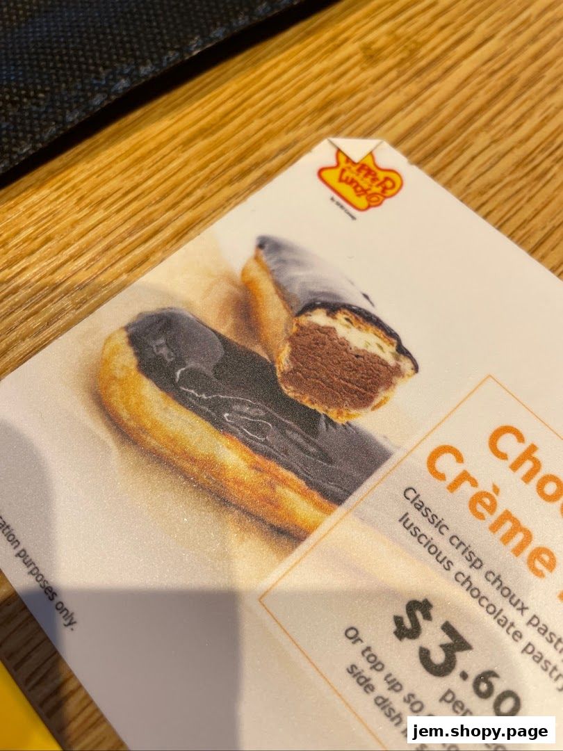 A close-up of a menu item featuring eclairs with chocolate glaze and filling.