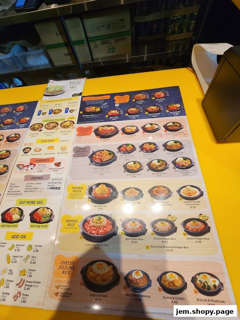 A menu board displaying various sizzling rice dishes, pasta, and add-on options.