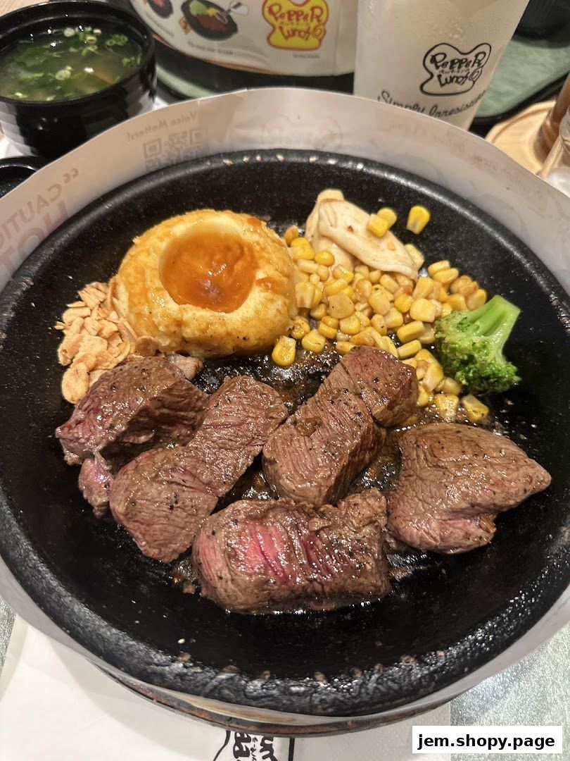 A sizzling steak dish with mashed potatoes, corn, broccoli, and soup from Pepper Lunch.
