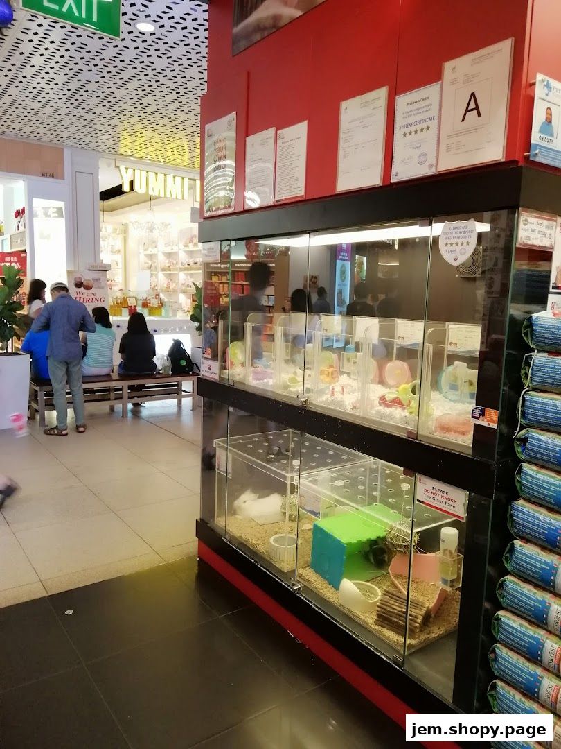 Interior view of Pet Lovers Centre showing small animal enclosures and retail displays.