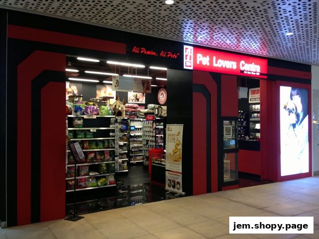 The entrance of Pet Lovers Centre, a pet supply store, with shelves stocked with pet products.