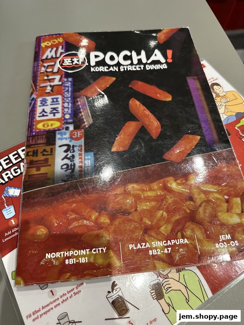 A menu cover for POCHA! Korean Street Dining featuring images of food and location details.
